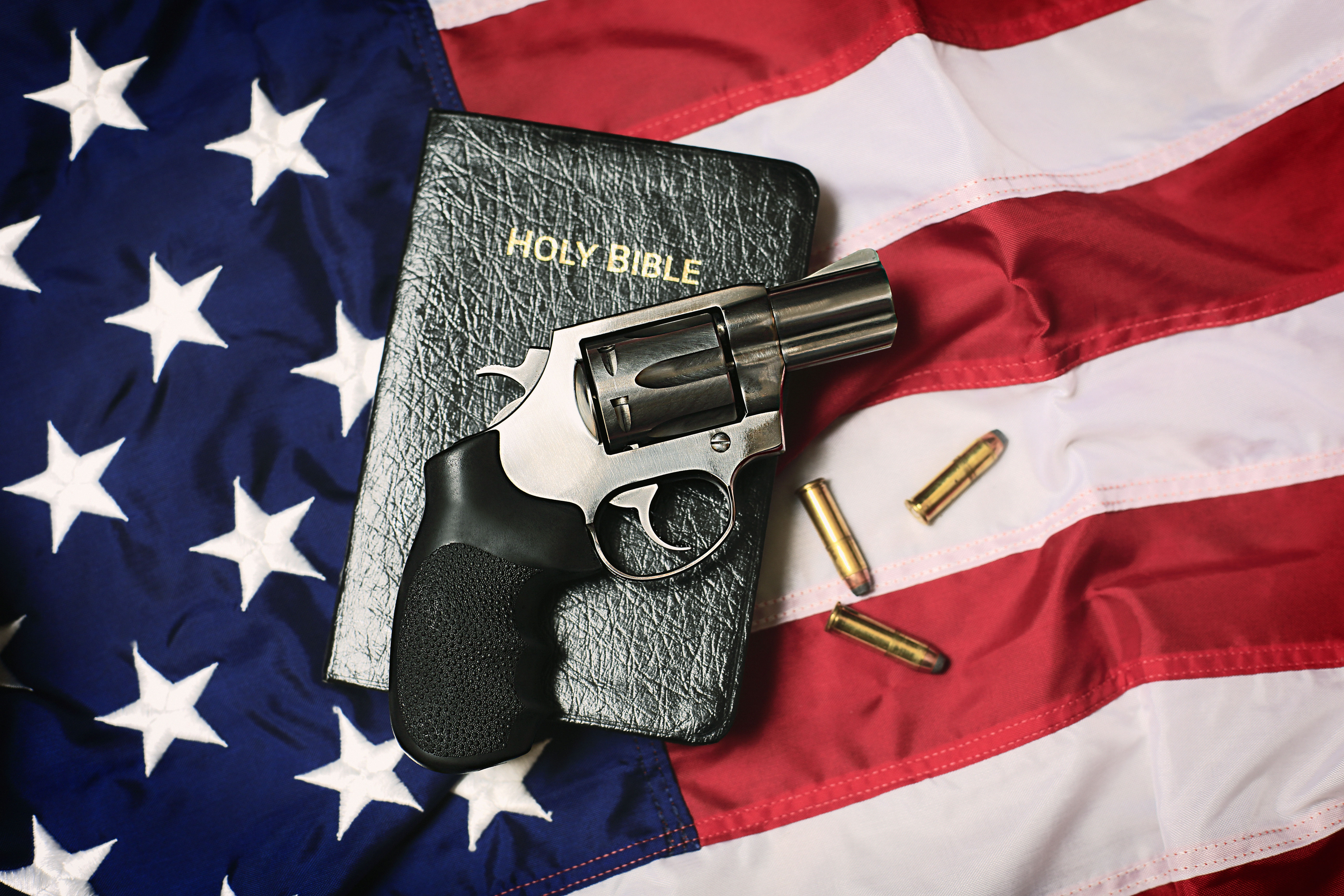 Gun and Bible on American Flag