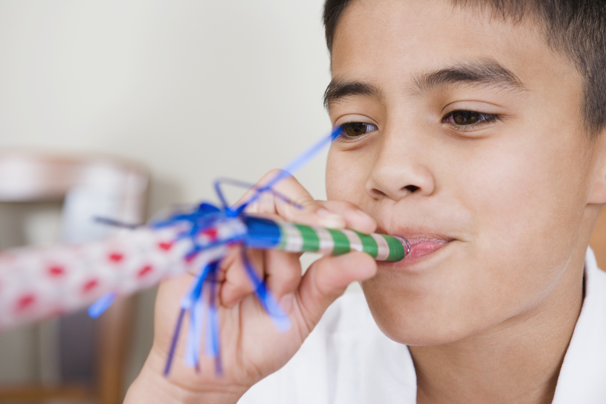 Boy Blowing Party Horn