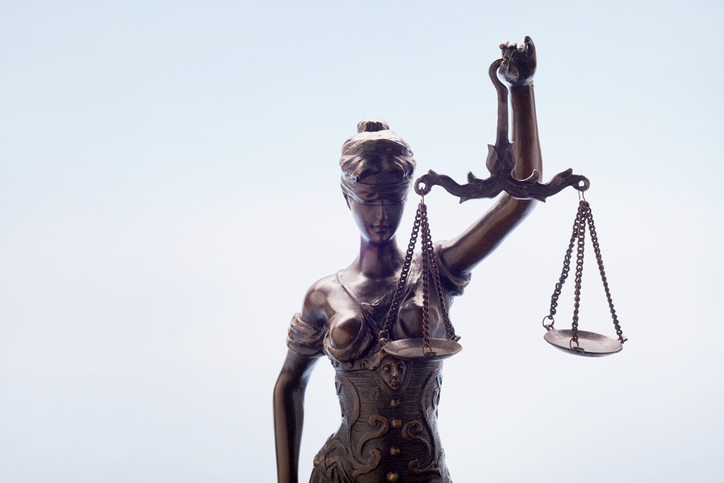 Lady Justice against blue background